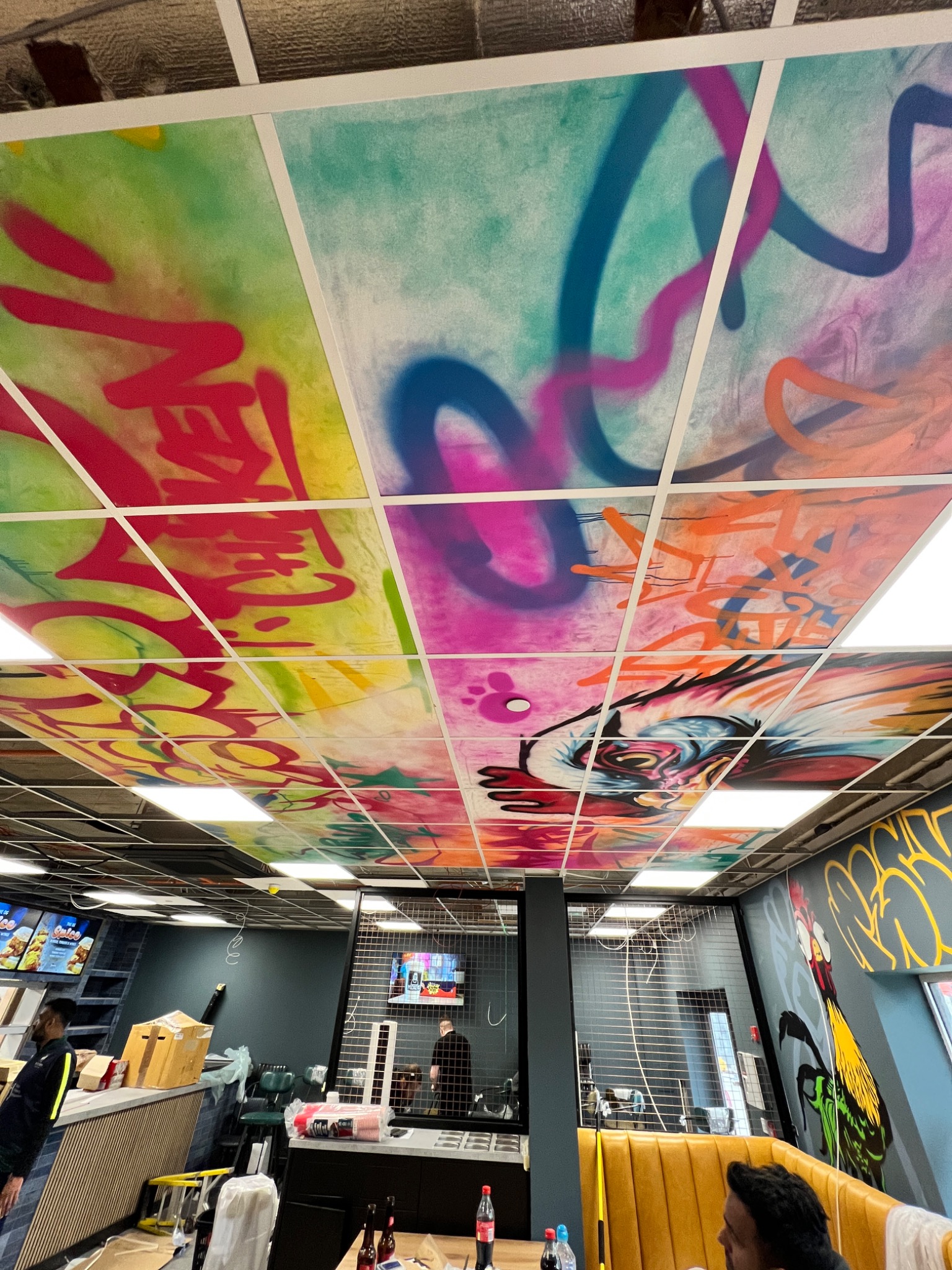 SlapUp artwork installed across a ceiling